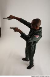 ERIC STANDING POSE WITH GUNS